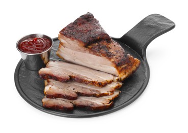 Photo of Pieces of tasty baked pork belly and sauce isolated on white