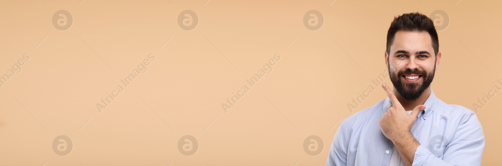 Image of Man showing his clean teeth and smiling on beige background, space for text. Banner design