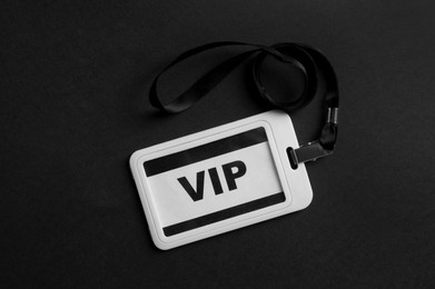 Photo of Plastic vip badge on black background, top view