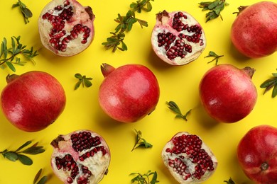 Photo of Flat lay composition with ripe pomegranates on yellow background