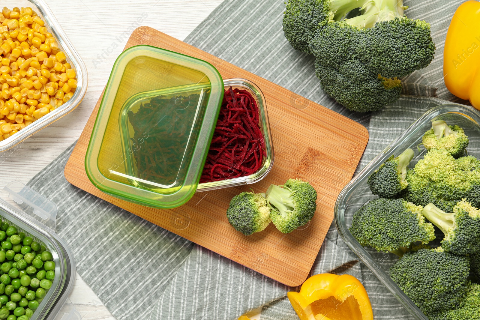 Photo of Containers with cut beetroot and fresh products on table, flat lay. Food storage