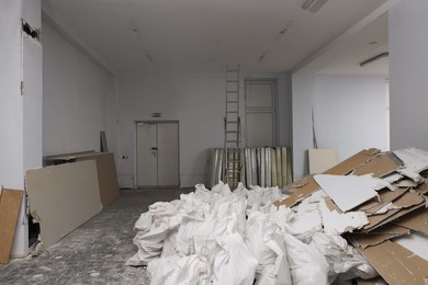 Photo of Used and new building materials in room prepared for renovation