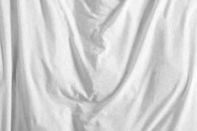 Crumpled white fabric as background, top view