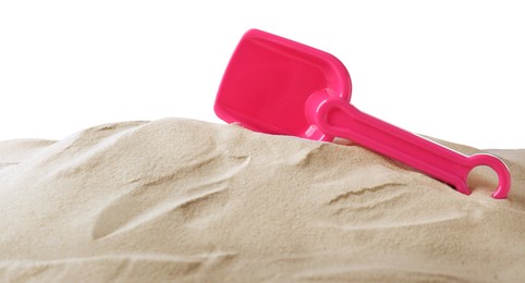 Photo of Bright pink plastic toy shovel on pile of sand