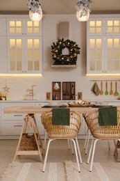 Photo of Spacious kitchen decorated for Christmas. Interior design