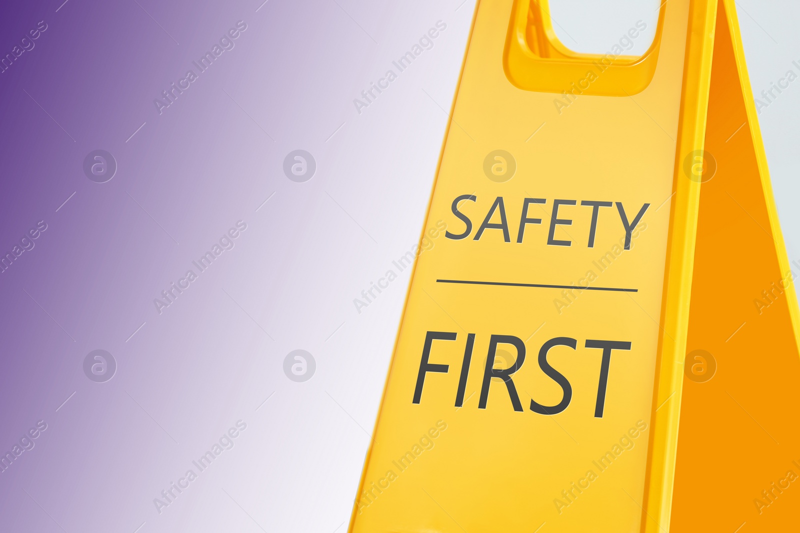 Image of Sign with phrase SAFETY FIRST on color background, space for text 