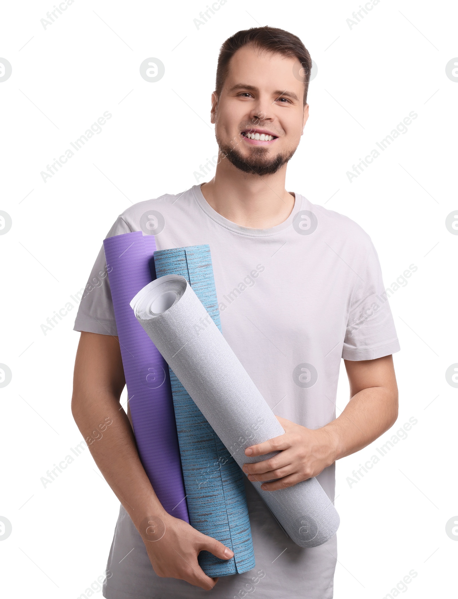 Photo of Man with wallpaper rolls on white background