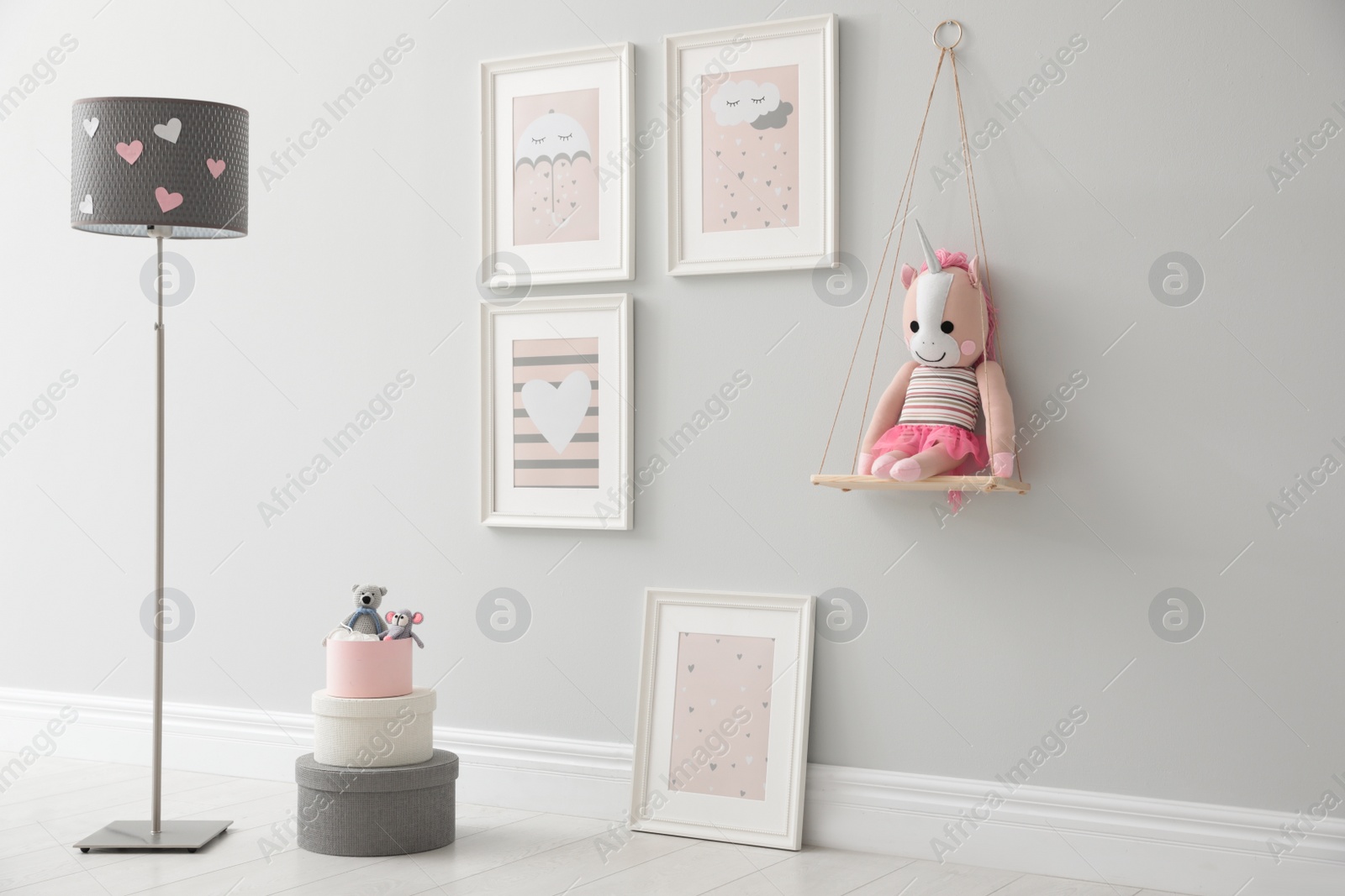 Photo of Children's room interior with floor lamp and cute pictures on wall