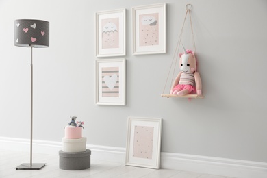 Children's room interior with floor lamp and cute pictures on wall