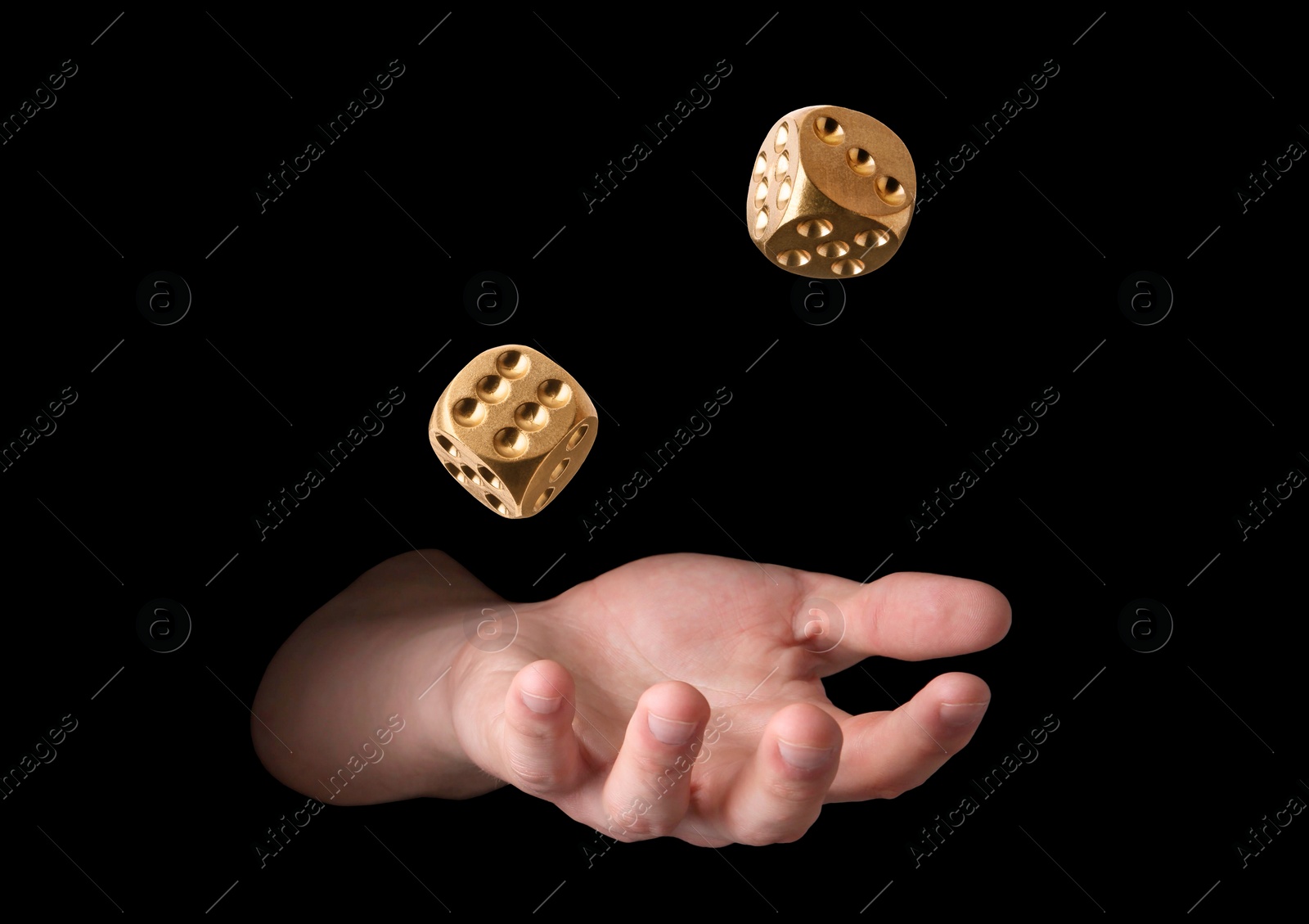 Image of Man throwing golden dice on black background, closeup