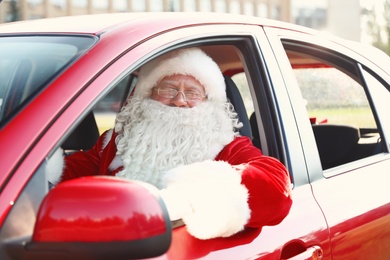 Authentic Santa Claus in car, view from outside