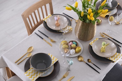 Photo of Beautiful Easter table setting with festive decor indoors, above view