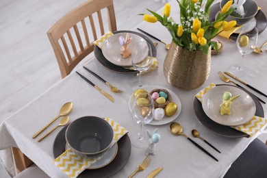 Beautiful Easter table setting with festive decor indoors, above view