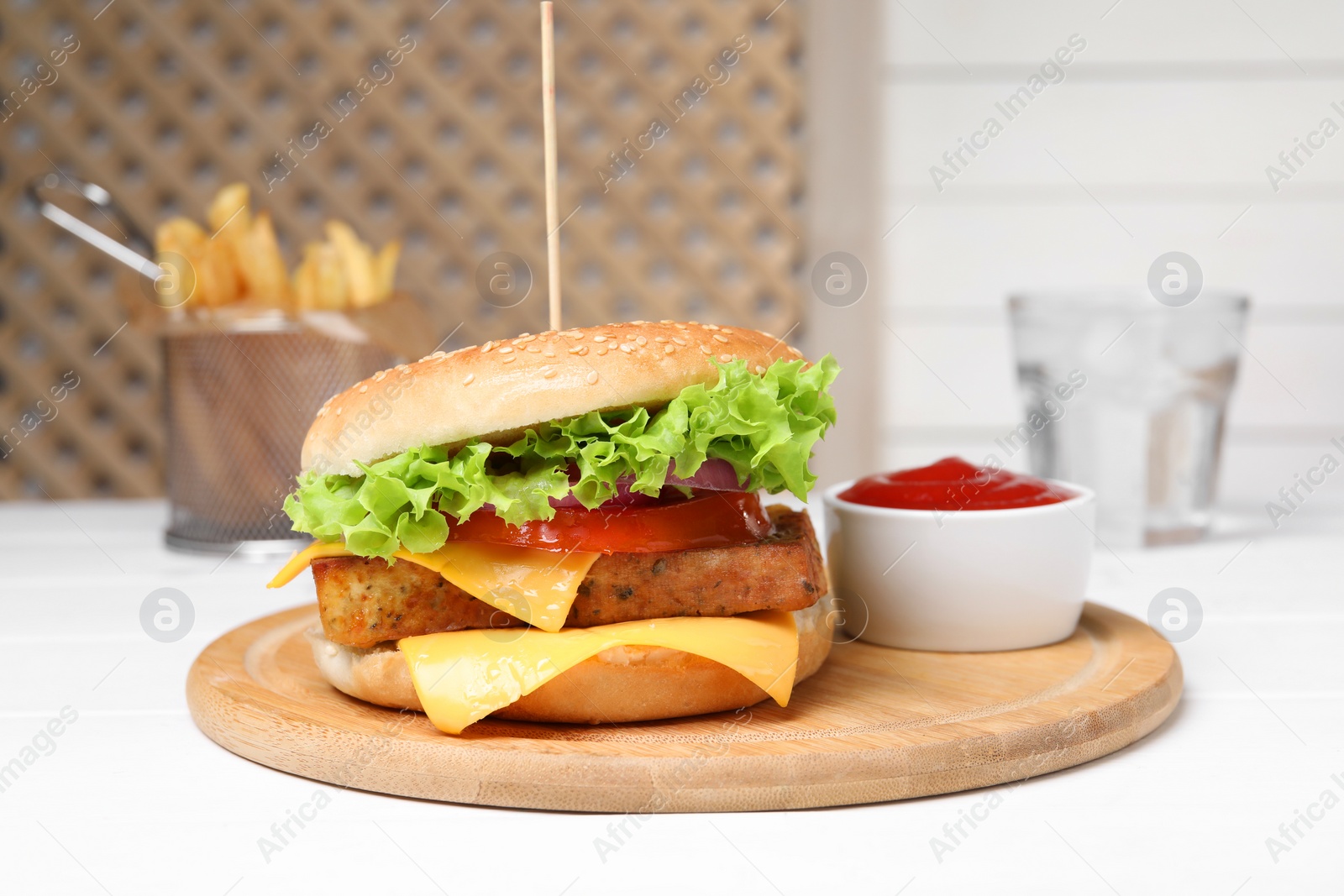 Photo of Delicious tofu burger served with sauce on white table