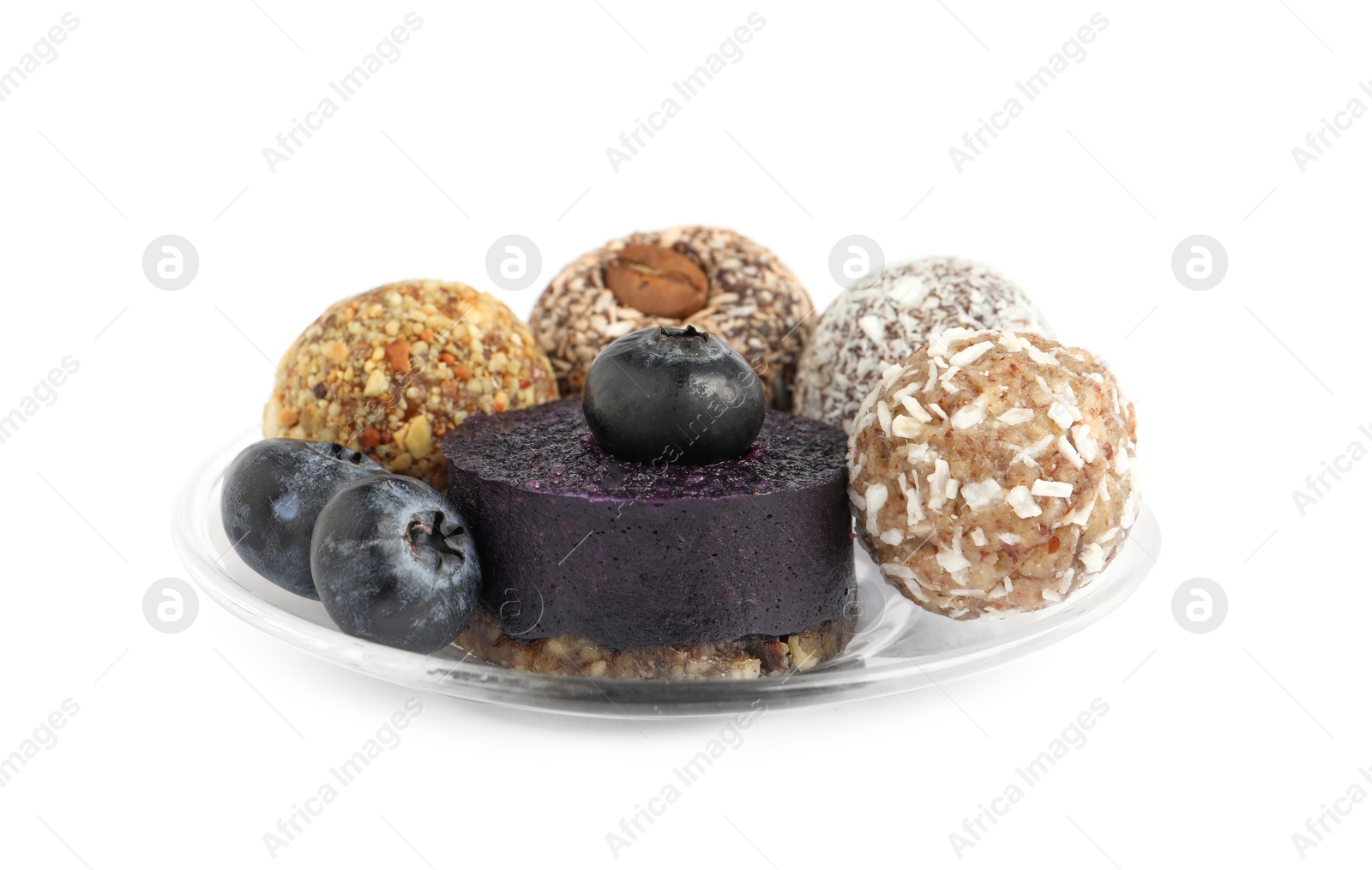 Photo of Different delicious vegan candy balls with fruit leather roll and blueberries on white background