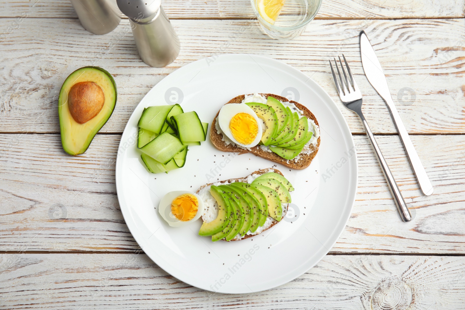 Photo of Tasty breakfast with crisp avocado  toasts on table, top view