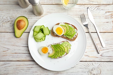 Tasty breakfast with crisp avocado  toasts on table, top view