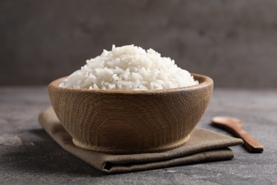 Bowl of tasty cooked rice served on table