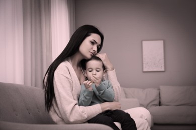 Image of Depressed single mother with child at home, color toned