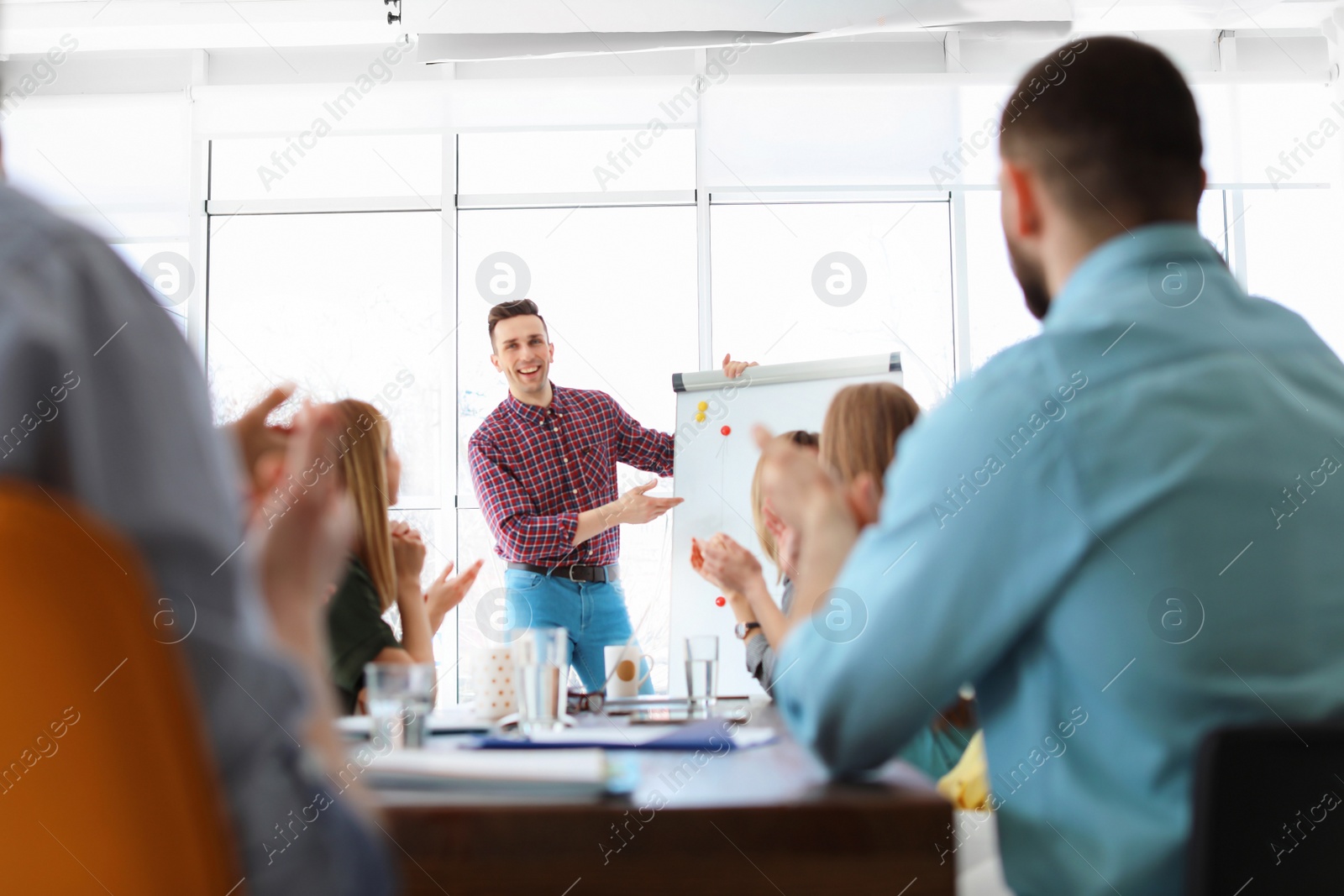 Photo of Male business trainer giving lecture in office