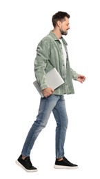 Man with laptop walking on white background