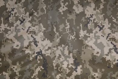 Photo of Texture of camouflage fabric as background, top view