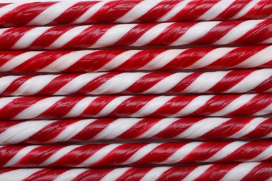 Photo of Top view of many sweet Christmas candy canes as background, closeup