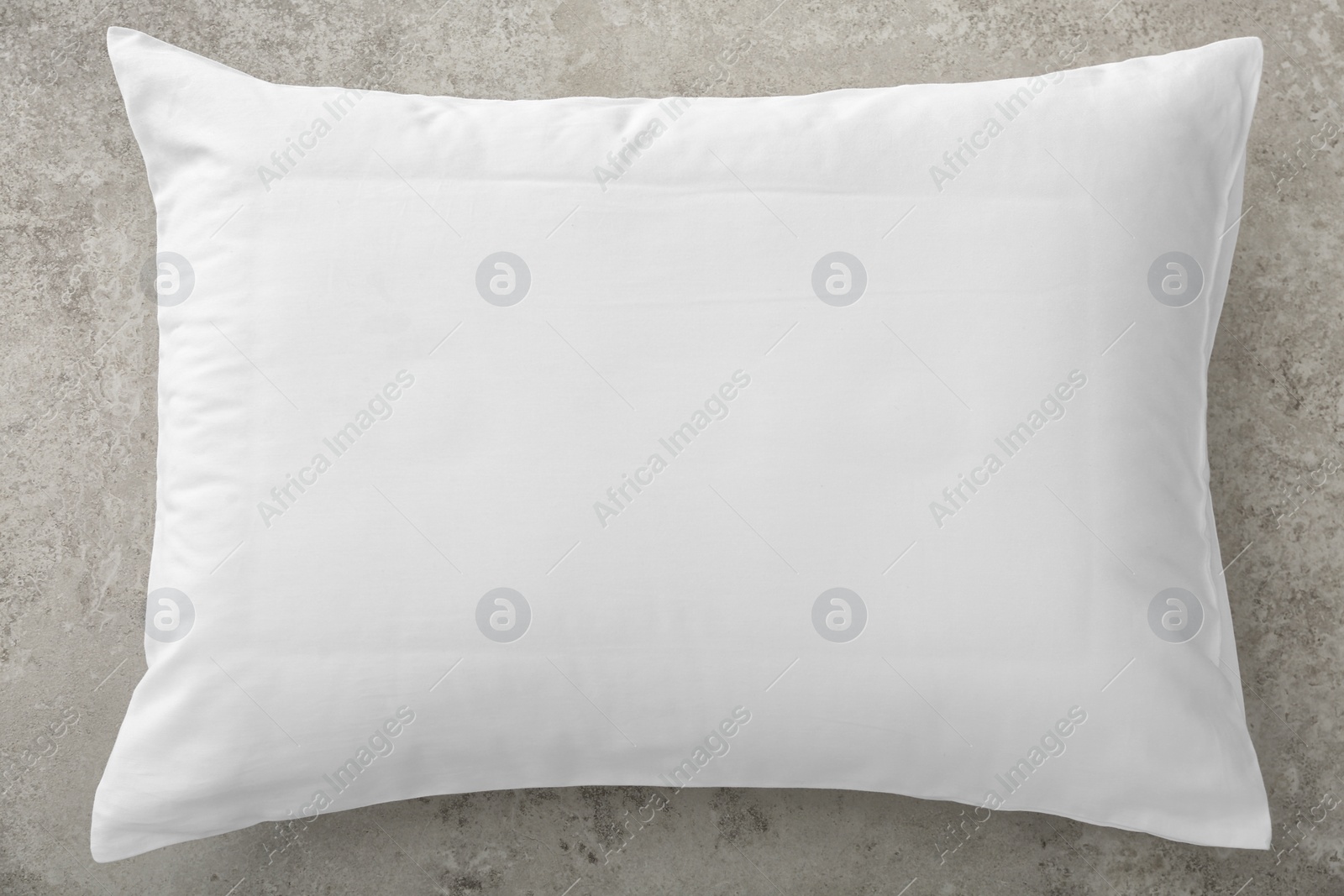 Photo of Soft bed pillow on gray background, top view