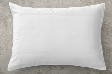 Soft bed pillow on gray background, top view