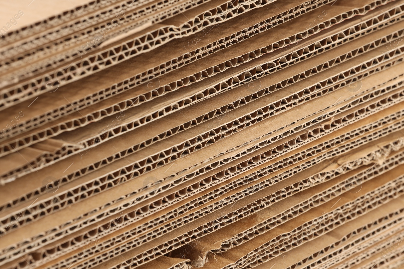 Photo of Sheets of brown corrugated cardboard as background, closeup