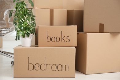 Photo of Pile of cardboard boxes indoors, closeup. Moving day