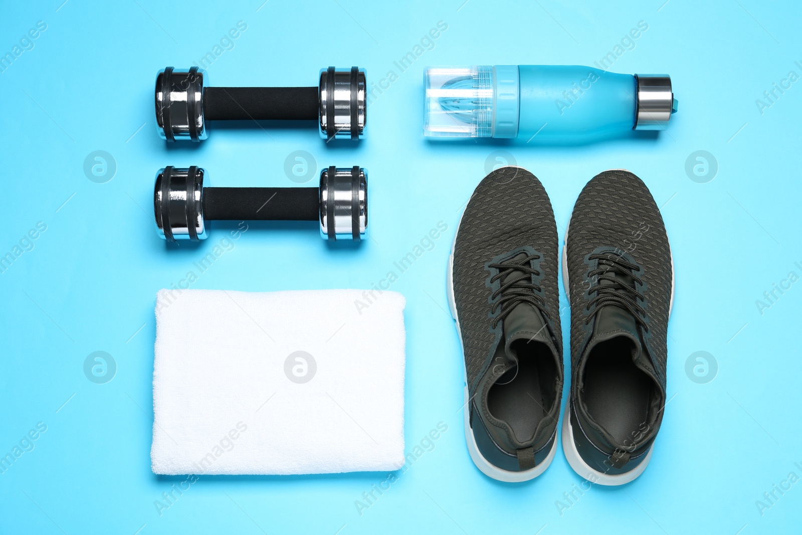 Photo of Man's sport items on light blue background, flat lay