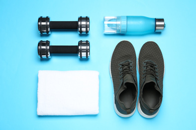 Man's sport items on light blue background, flat lay