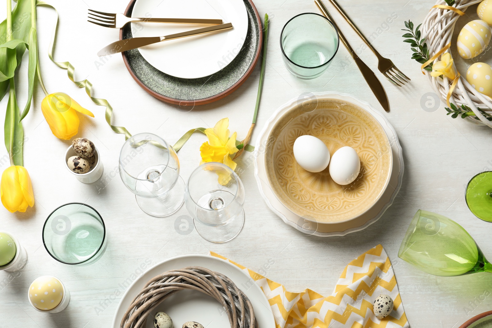 Photo of Festive Easter table setting with eggs on wooden background, top view