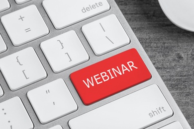 Online learning. Red button with word Webinar on computer keyboard, closeup