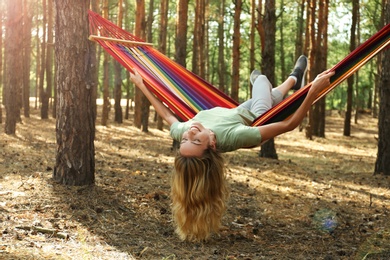 Photo of Woman resting in hammock outdoors on summer day