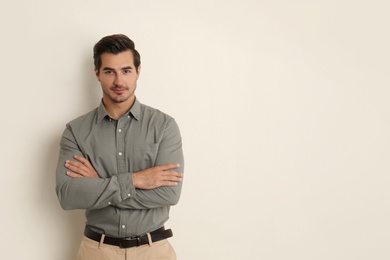 Photo of Young male teacher on beige background. Space for text