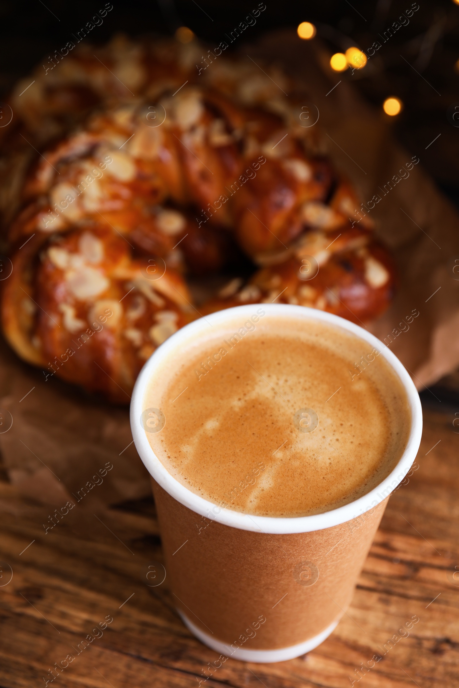 Photo of Delicious coffee and pastries on wooden table