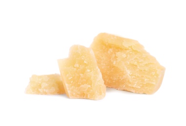 Photo of Pieces of delicious parmesan cheese on white background