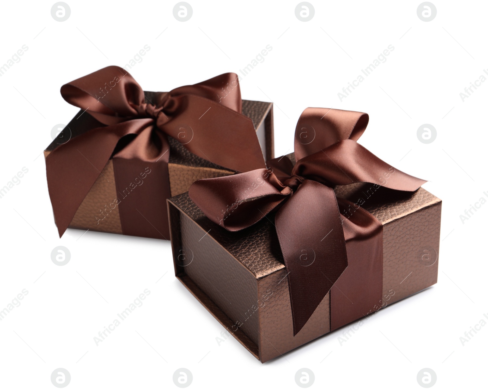 Photo of Brown gift boxes decorated with satin ribbon and bows on white background