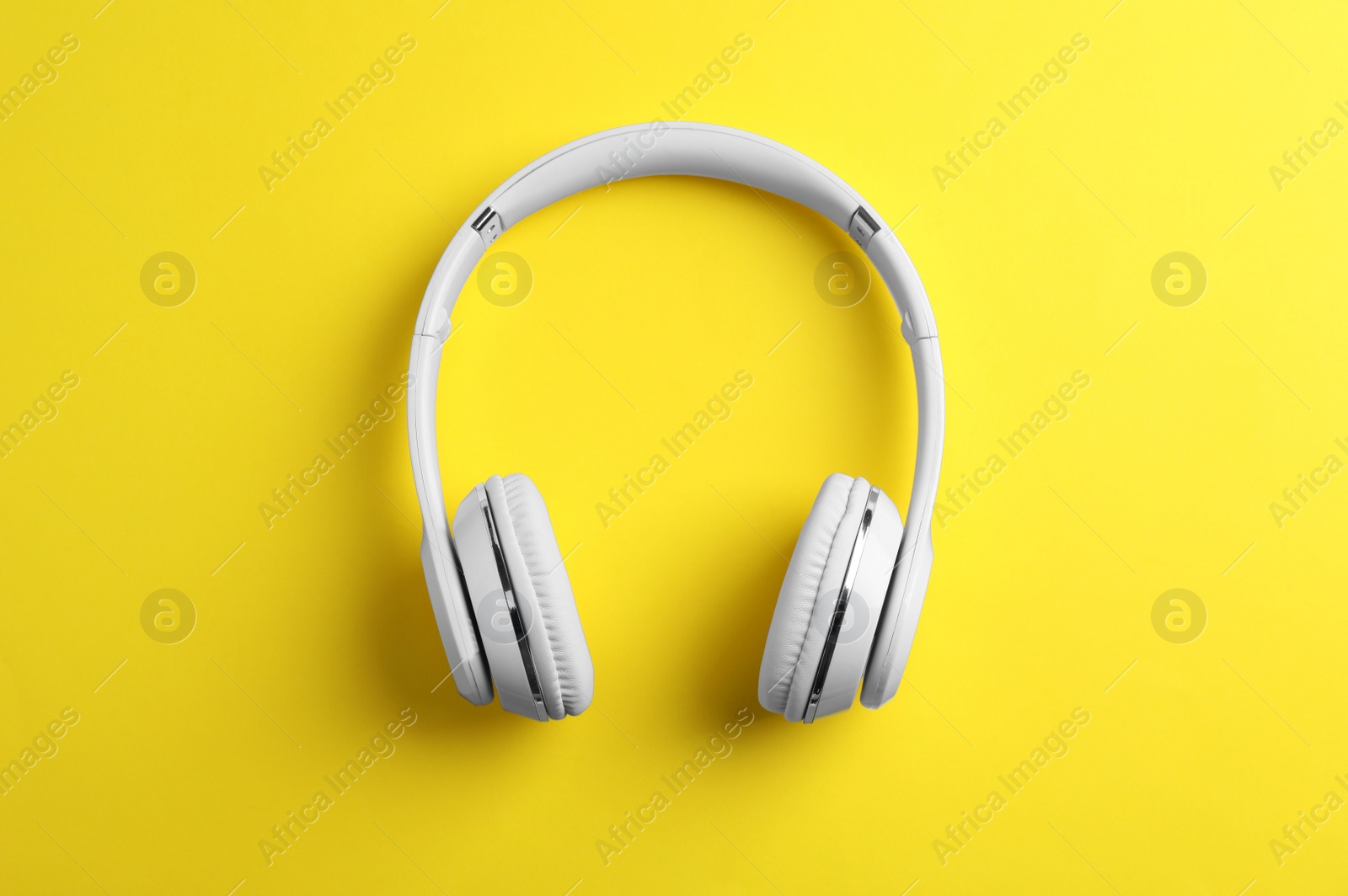 Photo of Wireless headphones on color background, top view