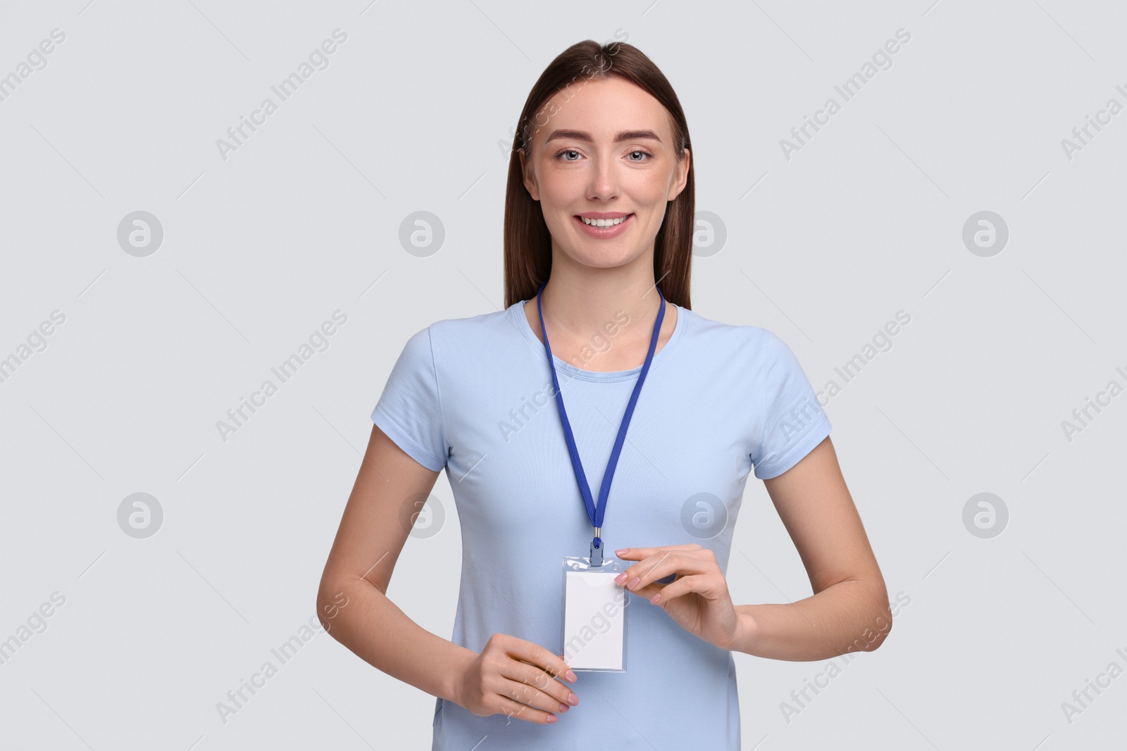 Photo of Woman with blank badge on grey background