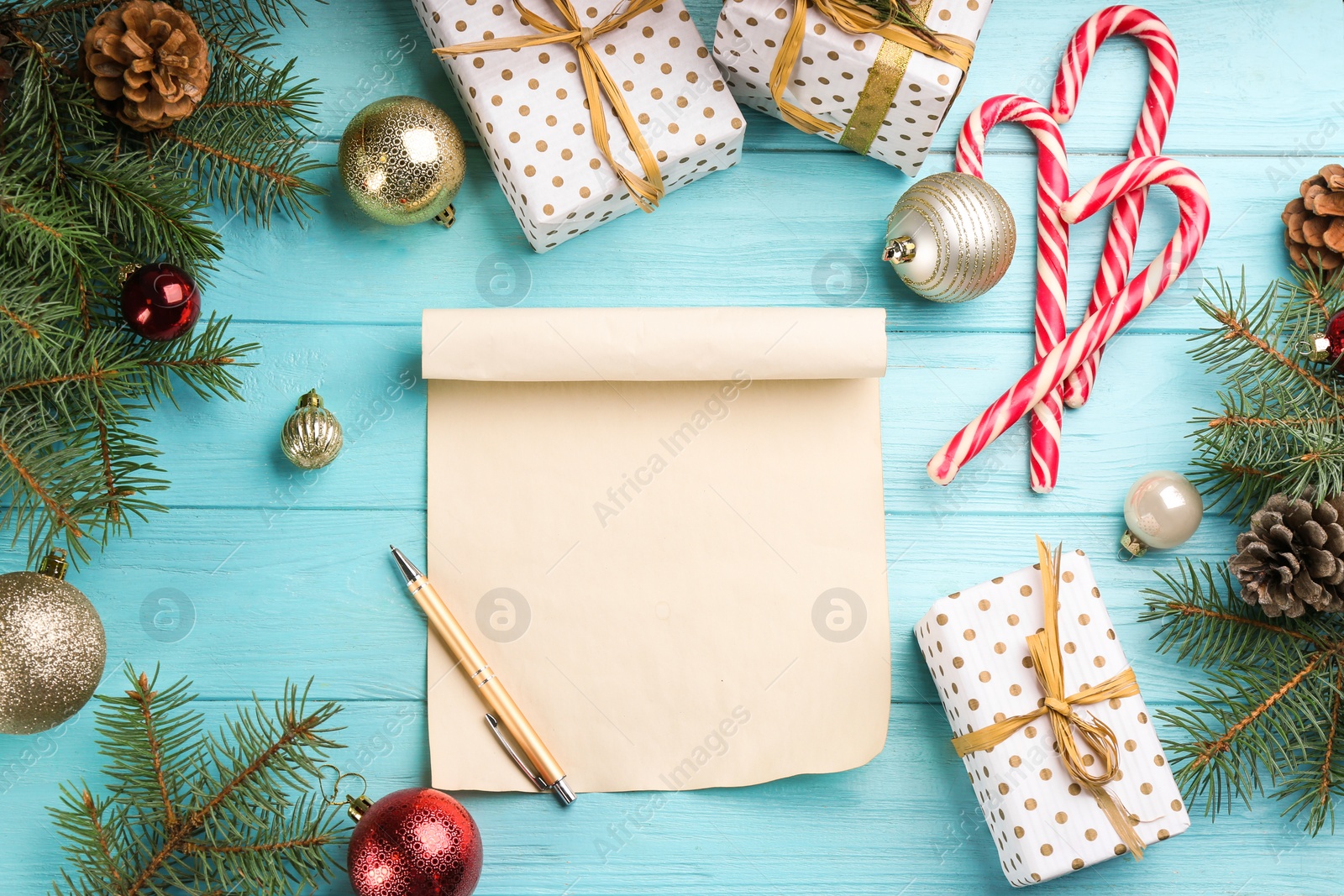 Photo of Flat lay composition with blank sheet of paper and Christmas decorations on turquoise wooden table, space for text. Writing letter to Santa