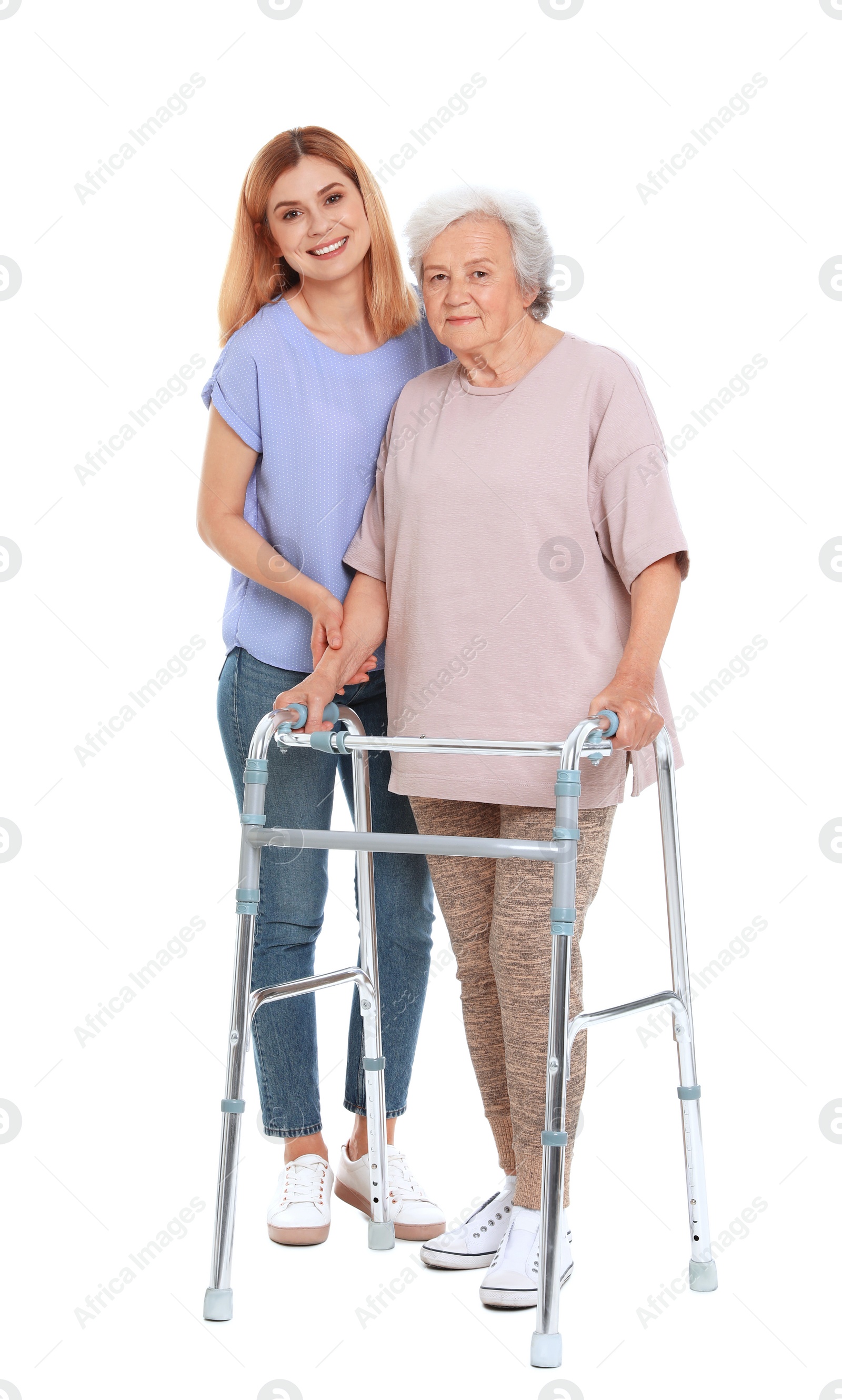 Photo of Caretaker helping elderly woman with walking frame on white background