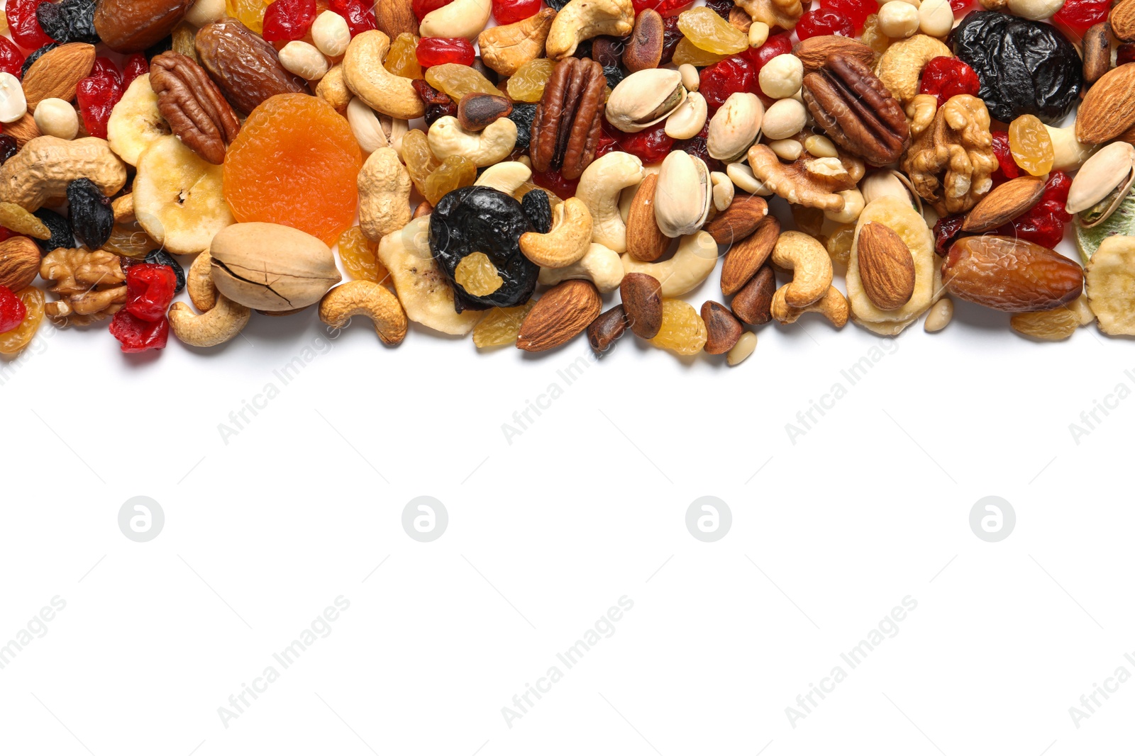 Photo of Different dried fruits and nuts on white background, top view. Space for text