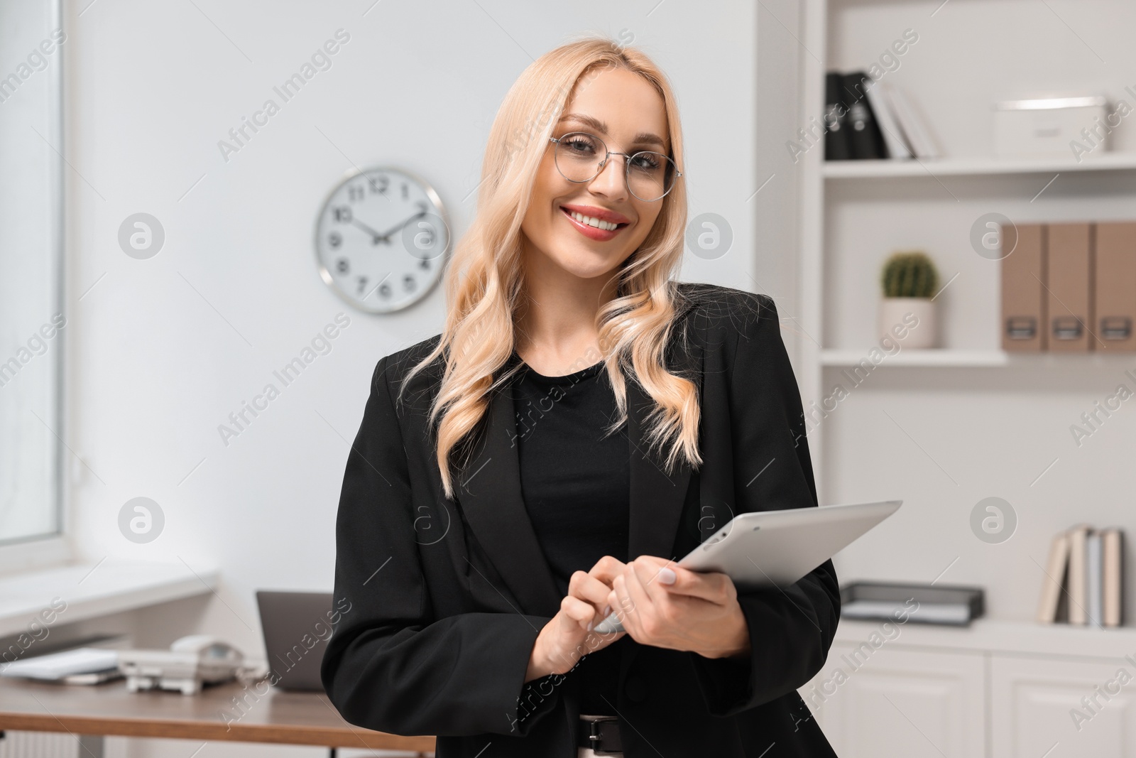 Photo of Portrait of happy secretary with tablet in office