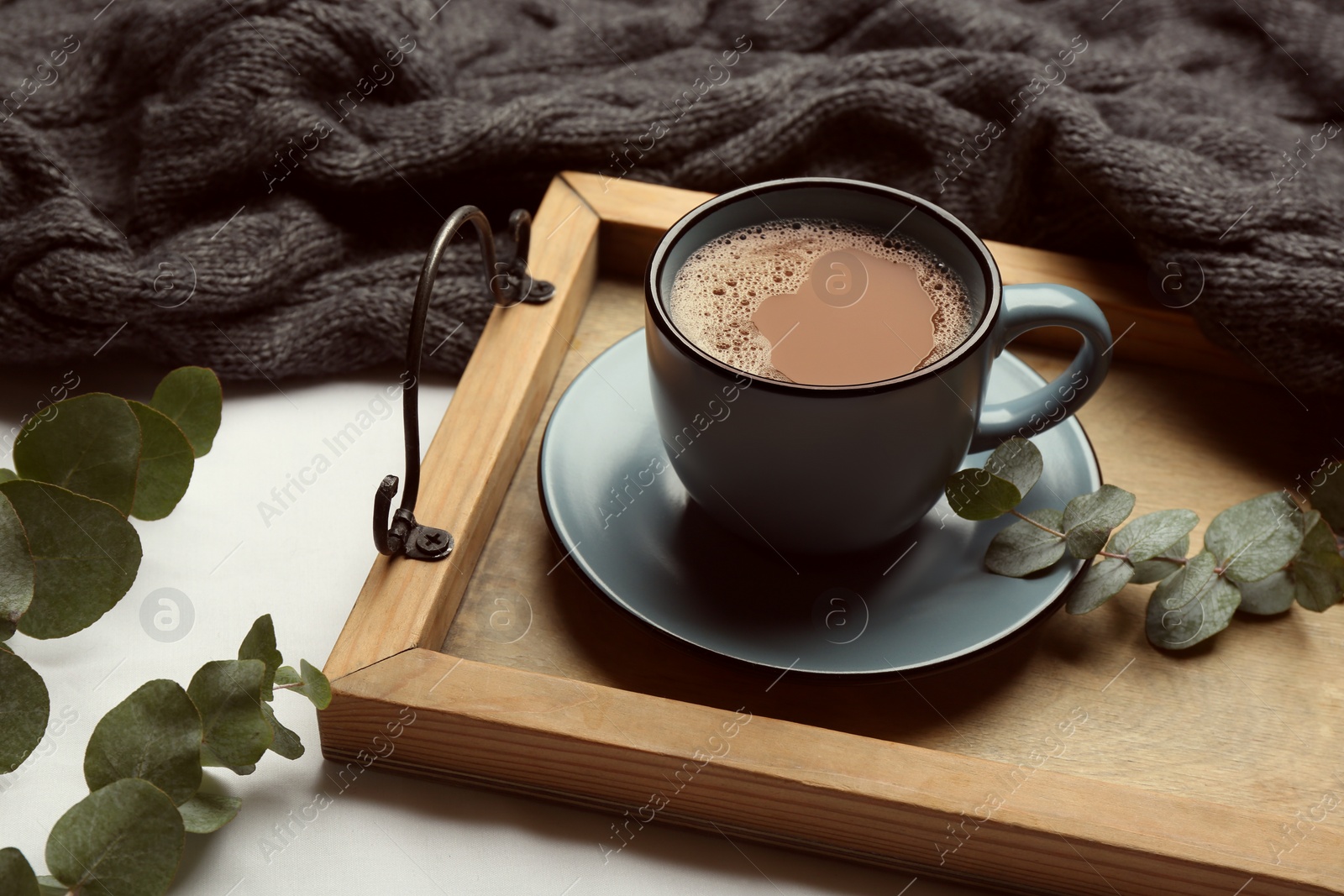 Photo of Composition with coffee and warm plaid on white background