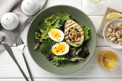 Healthy dish high in vegetable fats served on white wooden table, flat lay