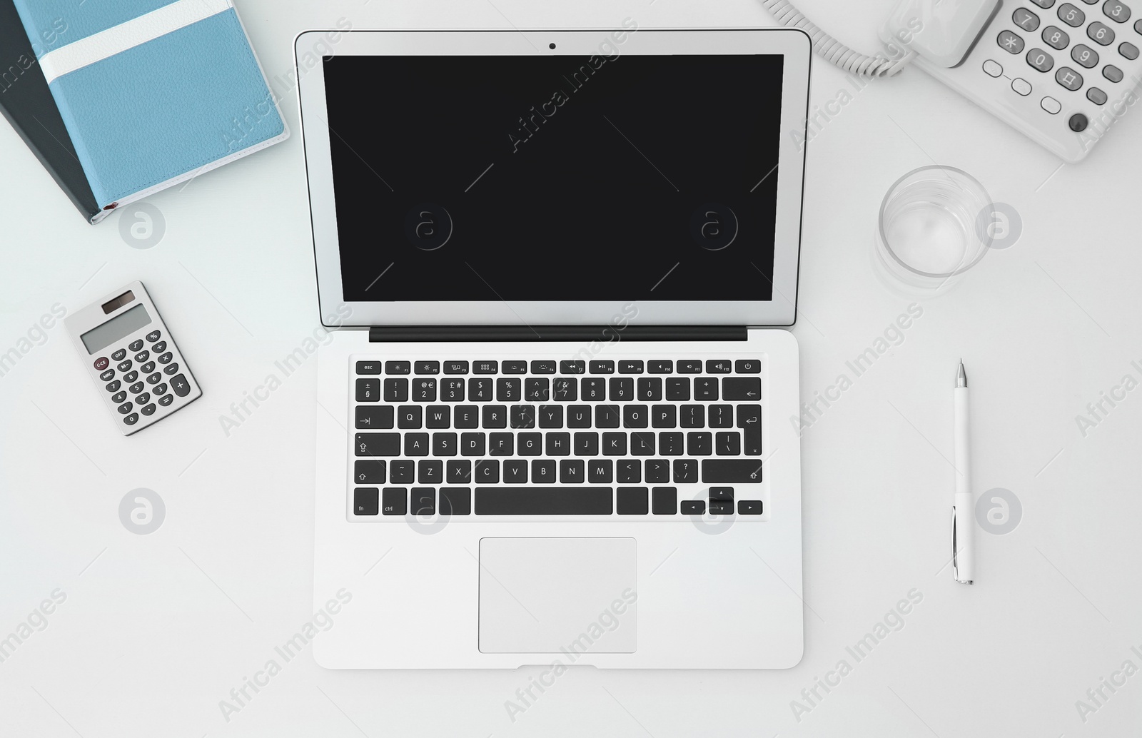 Photo of Stylish workplace with modern laptop on desk, top view