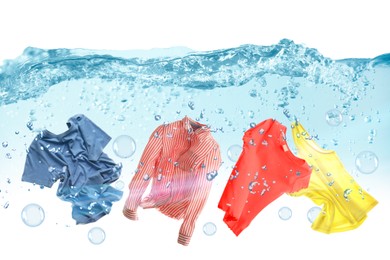 Image of Washing powder bubbles and clothes in water